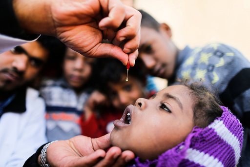 Girl is given vitamin A drops during a house-to-house vaccination campaign in Sanaa