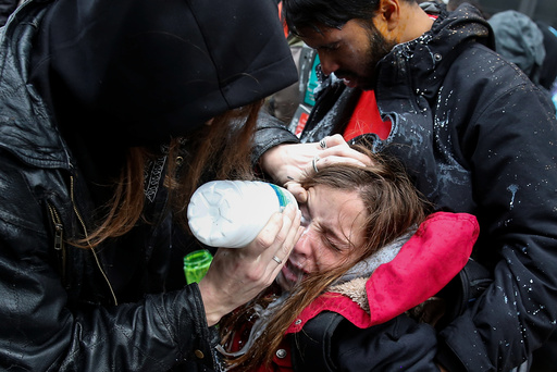 An activist is helped after being hit by pepper spray on the sidelines of the inauguration in Washington, D.C.