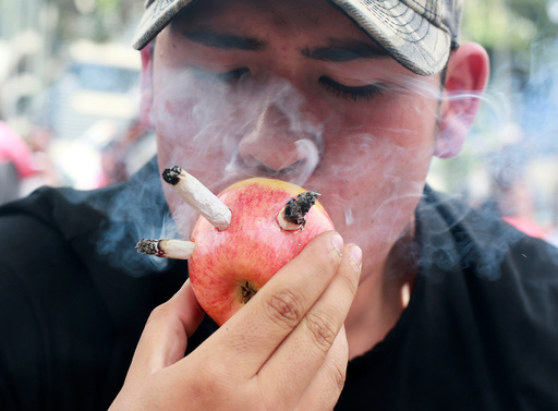 A man smokes marijuana during a global March for marijuana in Bogota, Colombia