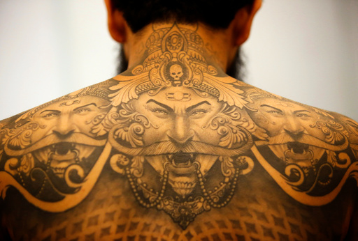 A tattoo of Hindu demon Ravan is pictured on a back of a man during the Nepal Tattoo Convention in Kathmandu