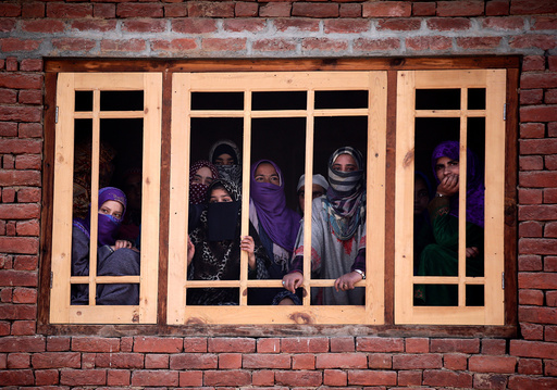Women watch the funeral of Rayees Ahmad Wani, a suspected militant who according to local media was killed in Padgampora in an encounter with the Indian security forces on Sunday, in Bellow village in south Kashmir