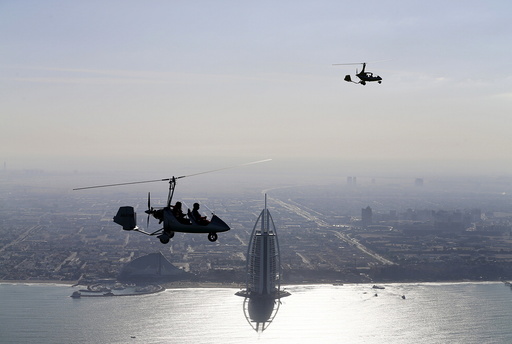 Gyrocopters fly over Dubai during the World Air Games 2015
