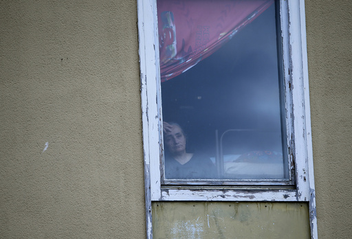 Woman looks out of window in refugee deportation registry centre in Manching