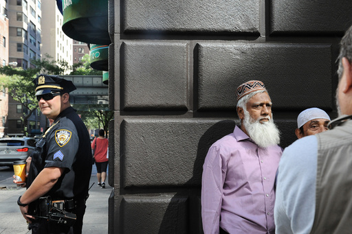 A member of the New York City police stands guard before the start of the annual Muslim Day Parade in the Manhattan borough of New York City