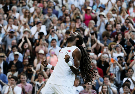 Dustin Brown of Germany celebrates after winning his match against Rafael Nadal of Spain at the Wimbledon Tennis Championships in London