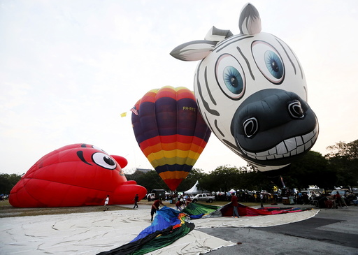 Balloons are inflated during the Hot Air Balloon festival in Putrajaya