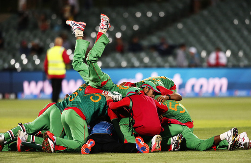 Bangladesh's Nassir Hossain leaps onto team mates in celebration after Bangladesh knocked England out of the tournament in their Cricket World Cup match in Adelaide