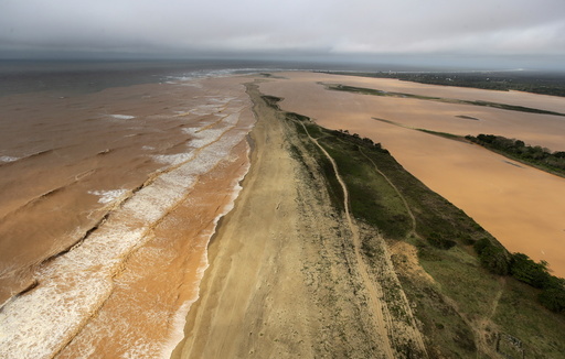 A general view the sea and Rio Doce, which was flooded with mud after a dam owned by Vale SA and BHP Billiton Ltd burst, as the river joins the sea on the coast of Espirito Santo in Povoacao Village