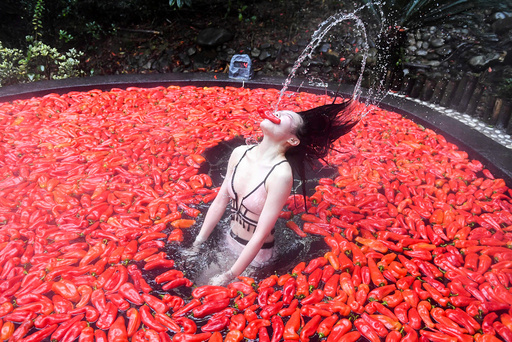 Participant takes part in a chilli-eating competition at a hot spring in Yichun