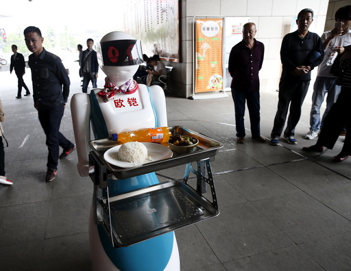 A robot works as a waitress for a restaurant in Xi'an