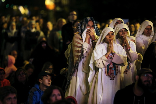 Nuns watch Pope Francis' speech on a screen during the Festival of Families rally along Benjamin Franklin Parkway in Philadelphia, Pennsylvania