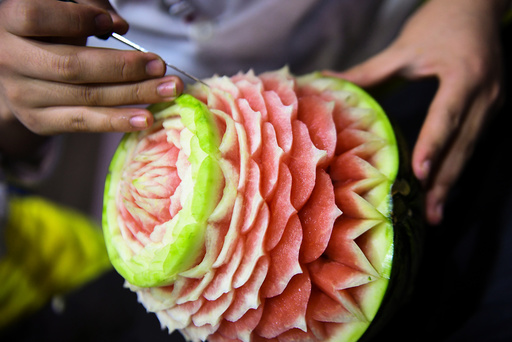A man carves a watermelon during a competition in Nanjing