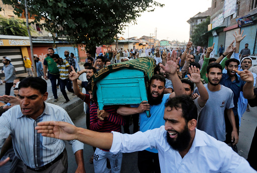 Kashmiri men carry a coffin containing the body of Abdul Qayoom during his funeral in Srinagar