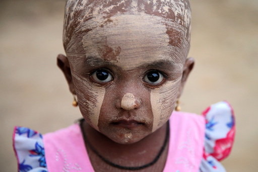 A girl wears thanakha powder on her face in a Rohingya refugee camp outside Kyaukpyu in Rakhine state, Myanmar