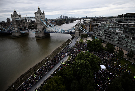 People attend a vigil to remember the victims of the attack on London Bridge and Borough Market, at Potters Field Park, in central London