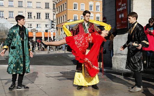 Illusionist Guillaume Arribart, performs on the street to demonstrate the levitation of an assistant to promote his show in central Lyon