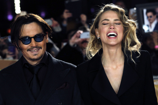 Actor Johnny Depp and girlfriend Amber Heard laugh as they arrive for the UK premiere of 