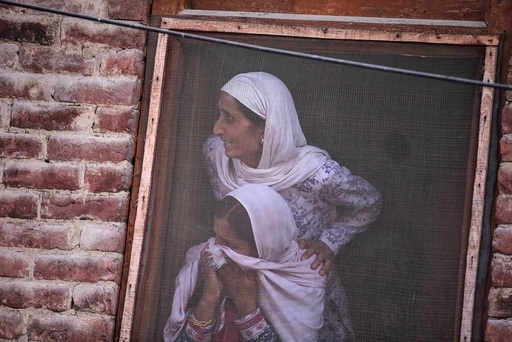 Kashmiri women watch the funeral of Muzaffar Ahmad Pandit, a civilian, who according to local media succumbed to injuries from pellets fired by Indian police during clashes earlier this month in Budgam