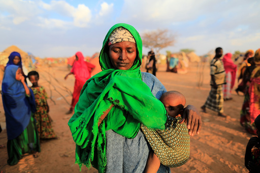 An internally displaced woman from drought hit area reacts after she complains about the lack of food at makeshift settlement area in Dollow, Somalia