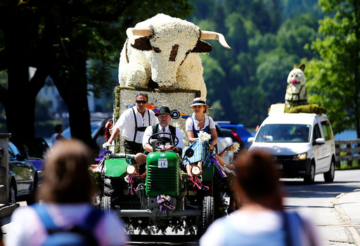 A figure made of daffodil blossoms arrives for a parade during the daffodil festival along Grundlsee lake in Grundlsee