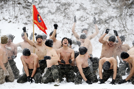 South Korean and U.S. Marines hurl snow during a winter military drill in Pyeongchang