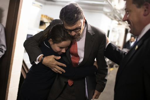 Rick Perry, the former governor of Texas, gets a hug from Madeline Martin, whose father leads the conservative interest group Perry was to address in St. Louis.