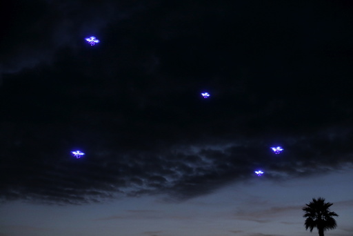 Drones fly in synchronization above attending conference goers as they dine outside along the ocean during the opening remarks at the beginning of the Wall Street Journal Digital Live ( WSJDLive ) conference at the Montage hotline Laguna Beach