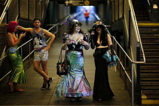 Participants of the Mermaid Parade arrive in a subway station in Brooklyn, New York