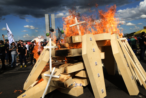 Striking police officers set fire to coffins during a protest by Police officers from several Brazilian states against pension reforms proposed by Brazil's president Michel Temer, in Brasilia