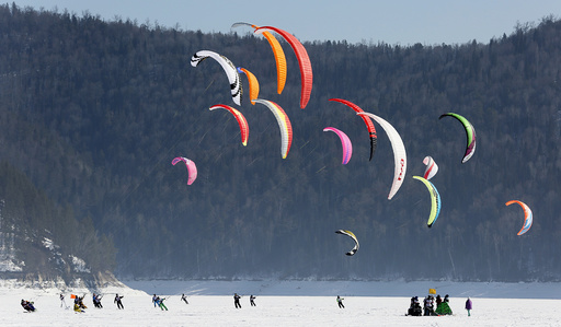 Kite boarders and kite skiers compete during a regional snow kiting championship outside Krasnoyarsk