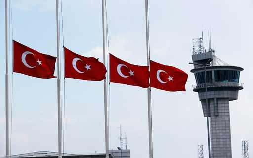 Turkish flags, with the control tower in the background, fly at half mast at the country's largest airport, Istanbul Ataturk, following yesterday's blast in Istanbul