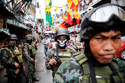 Armed security forces take a part in a drug raid, in Manila