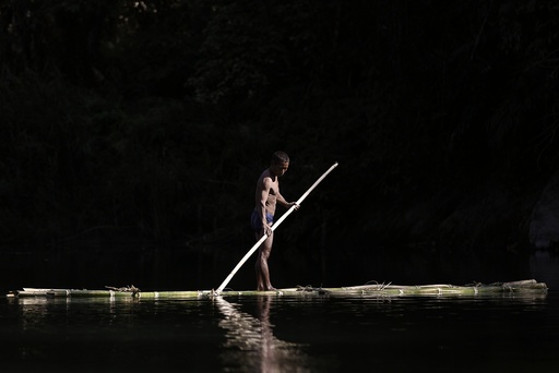 A Naga man manoeuvres a raft made of bamboo between Donhe and Lahe township in the Naga Self-Administered Zone