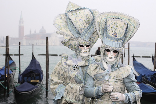 Masked reveller pose in San Marco Piazza during the Venice Carnival