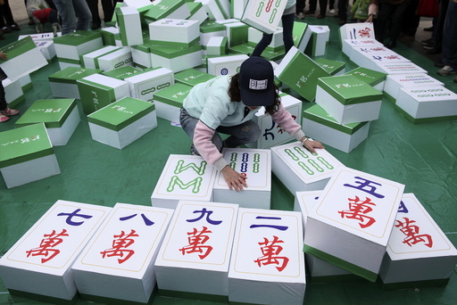 A woman participates in a giant mahjong game in Kunming