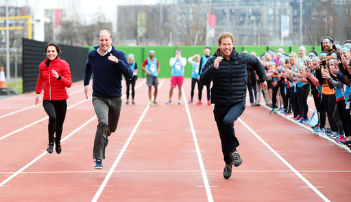 Britain's Prince William, Kate, Duchess of Cambridge, and Prince Harry take part in a relay race, at the Queen Elizabeth II Park in London