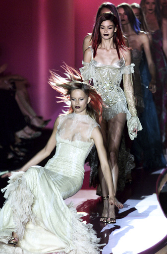 A MODEL FALLS TO THE CATWALK AT VERSACE AUTUMN-WINTER 2002/2003 COLLECTION IN PARIS.