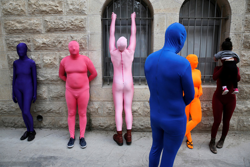 Members of the Prizma Ensemble wearing full solid-coloured bodysuits take part in the 6th Jane's Walk Jerusalem in Jerusalem