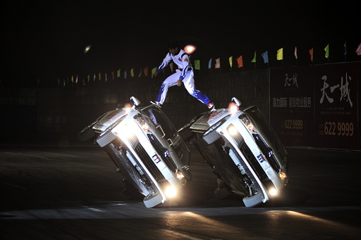 Stunt drivers perform during a drift game in Taiyuan