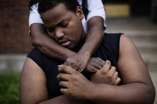Miles Turner is hugged by his mother Angela outside their home in Chicago