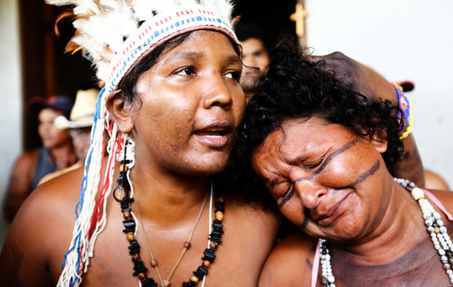 Preta and Gabao from Brazil's indigenous Gamela tribe react after members of their tribe were injured in a dispute over land in northern Brazil