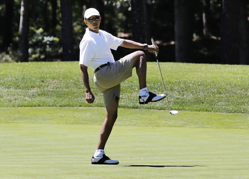 U.S. President Obama reacts after missing putt on the first green at golf course on Martha's Vineyard