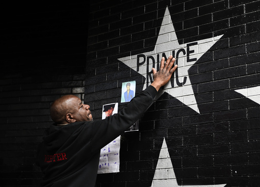 Donnie Straub of Minneapolis touches a star bearing U.S. music superstar Prince's name on an exterior wall of First Avenue in Minneapolis Minnesota