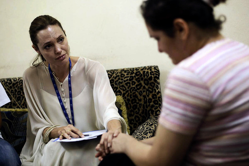 UNHCR Goodwill Ambassador Angelina Jolie listens as an Iraqi refugee woman talks about her experience in Iraq, in Jaramana