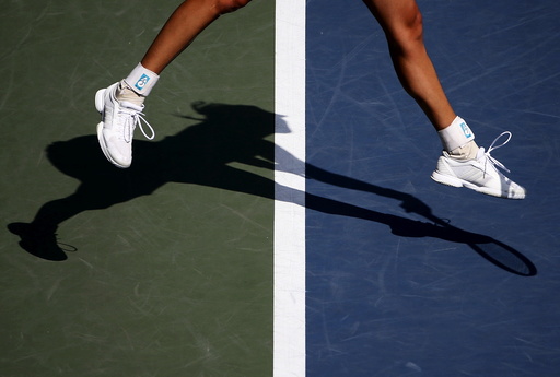 Muguruza of Spain casts a shadow as she serves to Strycova of the Czech Republic during their Pan Pacific Open women's singles tennis match in Tokyo
