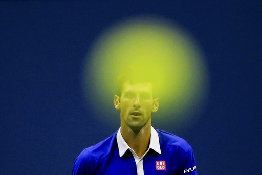 Djokovic of Serbia follows the flight of his ball as he returns to Federer of Switzerland during their men's singles final match at the U.S. Open Championships tennis tournament in New York