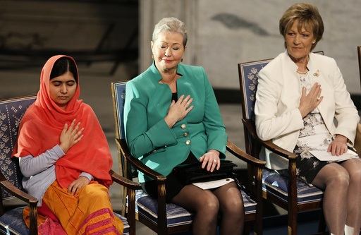 Nobel Peace Prize laureate Yousafzai reacts next to Norwegian Nobel committee members Kullman-Five and Marie during the Nobel Peace Prize awards ceremony at the City Hall in Oslo