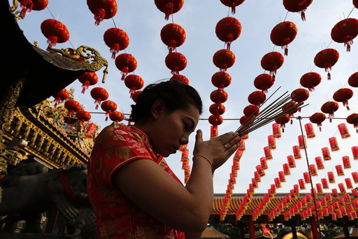 A woman prays in a temple decorated to celebrate Chinese New Year at Samut Prakan province outside Bangkok