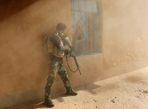 An Iraqi soldier searches a house during clashes with Islamic State fighters in Al-Qasar, South-East of Mosul