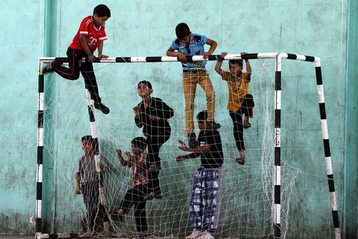 Refugee children play before start of a soccer match in the Al-Baqaa Palestinian refugee camp, near Amman